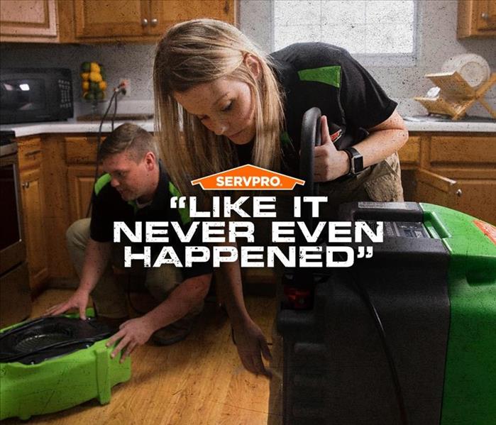 SERVPRO workers in a kitchen with their drying equipment