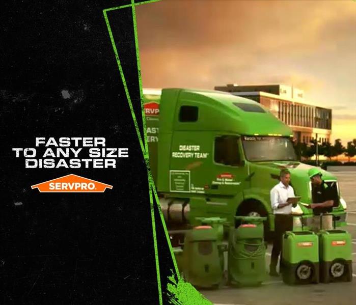 SERVPRO truck and employees standing with equipment